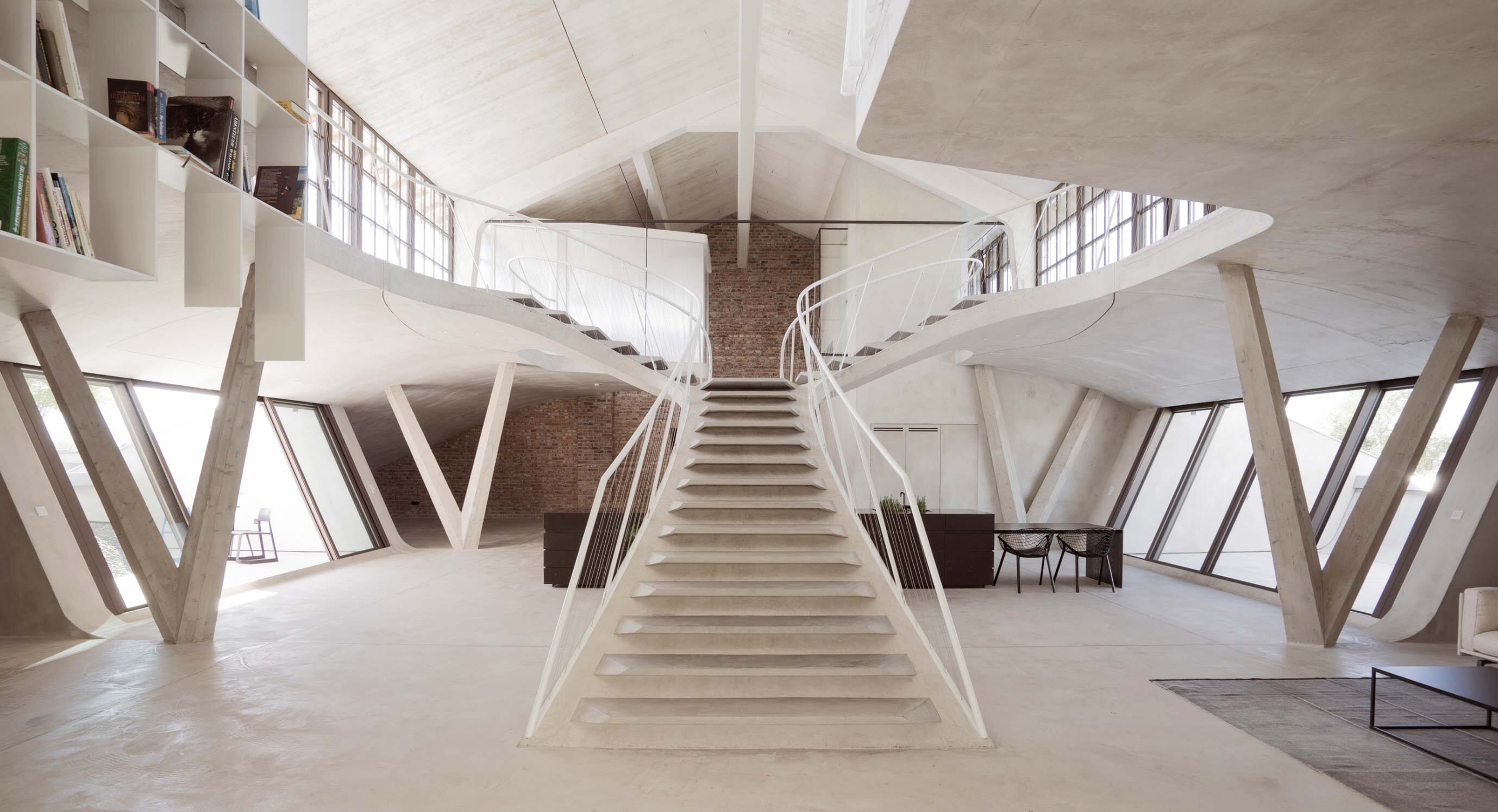 Smartvoll adds sculptural concrete staircase to Salzburg loft