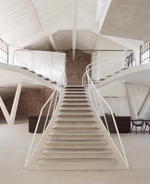 Smartvoll adds sculptural concrete staircase to Salzburg loft